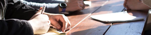Hands on desk at meeting